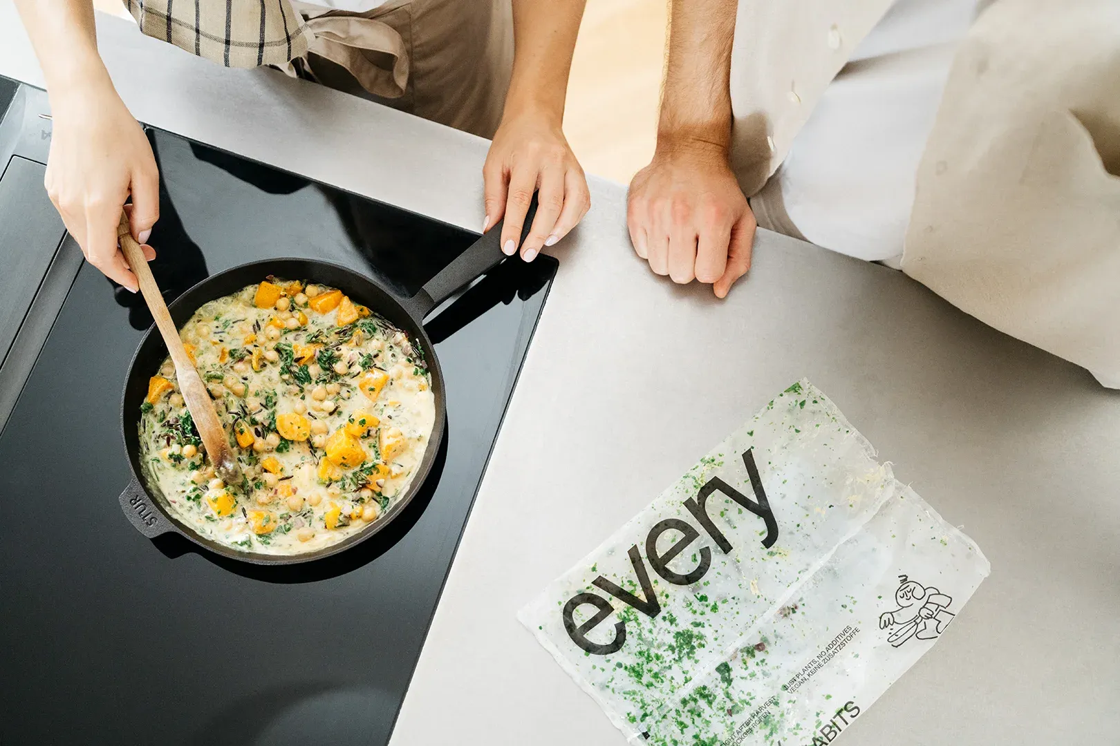 An every meal cooking in a pan next to its pouch