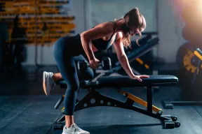 Woman performing a dumbbell row during strength training