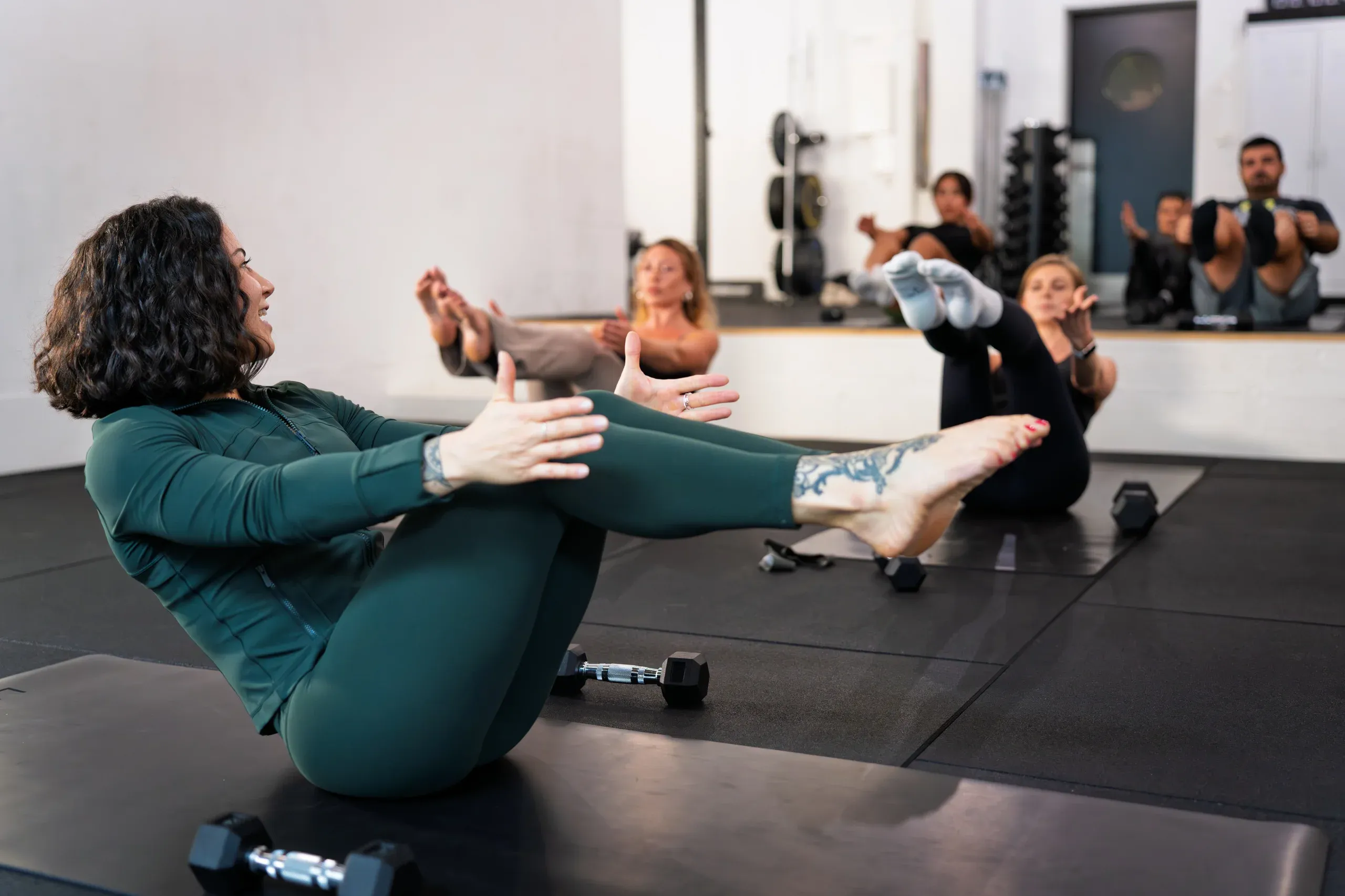 Coach leading a small group mat class at Inspired Movement